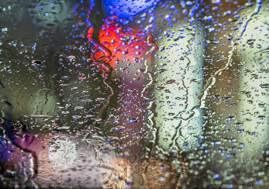 A leaky car window with water on the inside.