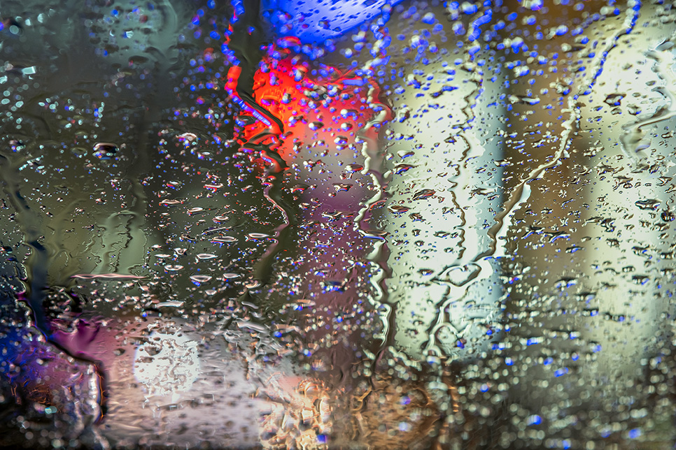 A leaky car window with water on the inside.