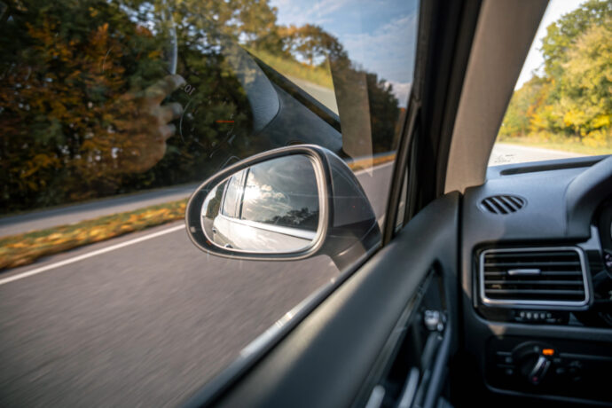 view of driver's side window and mirror with ADAS