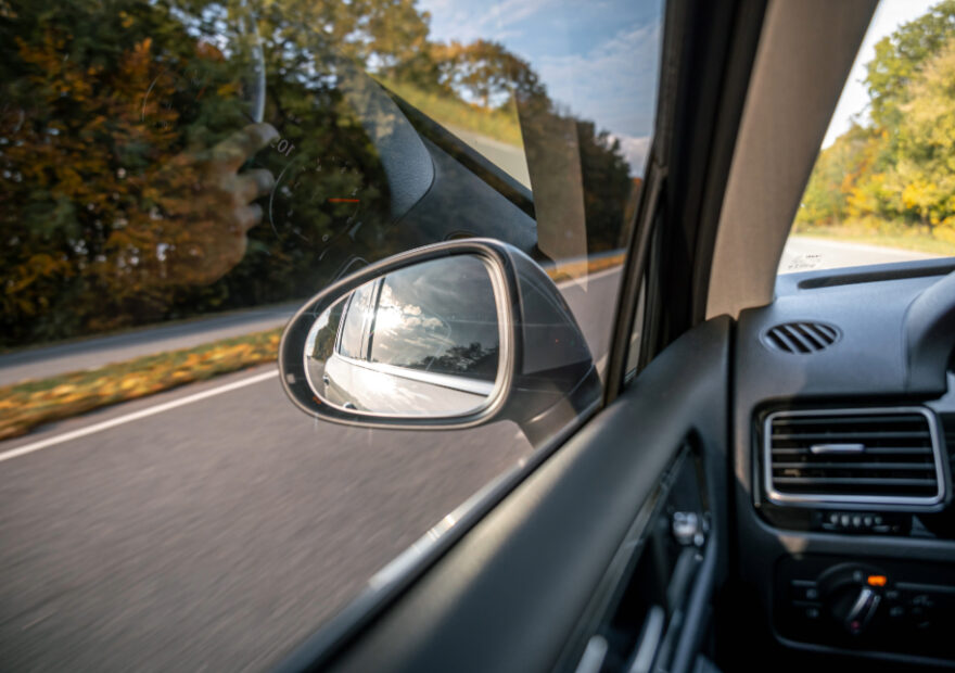 view of driver's side window and mirror with ADAS